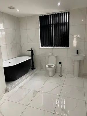 a bathroom with a tub and a toilet and a sink at Brownlows Inn in Liverpool