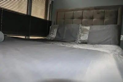 a large bed with white sheets and pillows at Brownlows Inn in Liverpool