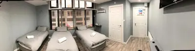a room with two beds and a window at Brownlows Inn in Liverpool