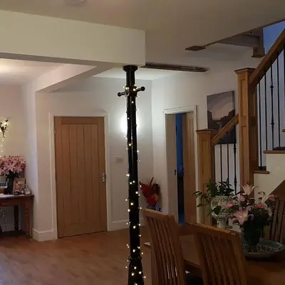 a living room with a christmas pole with lights at Saracens House in Preesall