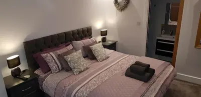 a bedroom with a large bed with pillows at Saracens House in Preesall