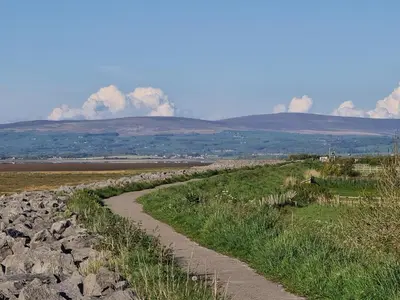 a stone path on a hill with mountains in the background at Dolphin House in Preesall