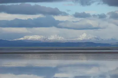 a view of snow covered mountains from the water at Dolphin House in Preesall