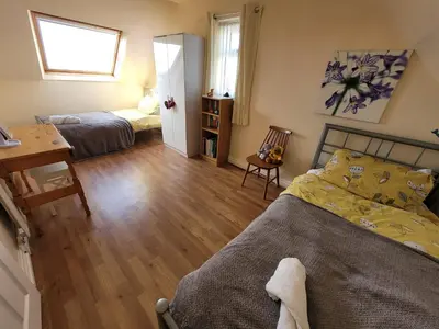 a bedroom with a bed and a desk and a desk at Dolphin House in Preesall