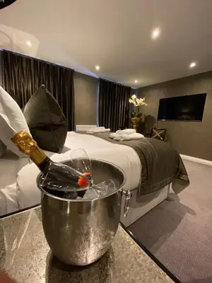 a bedroom with a bottle of champagne in a tub at The Bold Hotel; BW Signature Collection in Southport