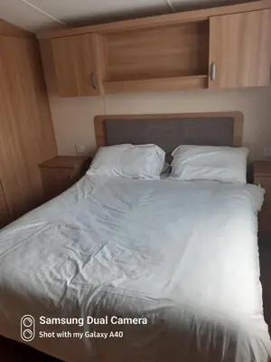 a bedroom with a bed with white sheets and pillows at Family Holidays Blackpool in Blackpool