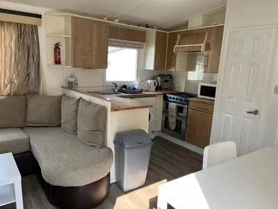 a small kitchen with a couch and a table at Family Holidays Blackpool in Blackpool