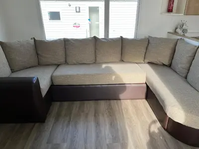 a large couch in a living room at Family Holidays Blackpool in Blackpool