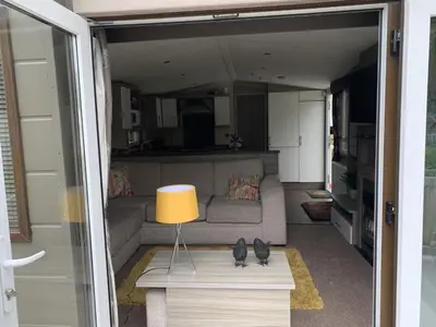 a living room with a couch and a table with a lamp at Family Holidays Blackpool in Blackpool