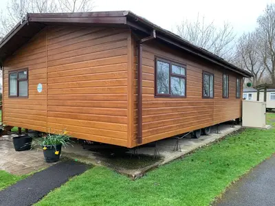 a large wooden house in a yard at Family Holidays Blackpool in Blackpool