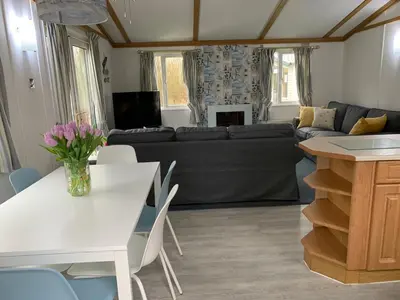 a living room with a white table and a couch at Family Holidays Blackpool in Blackpool