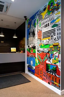 a wall in a room with a mural of cities at Heeton Concept Hotel - City Centre Liverpool in Liverpool
