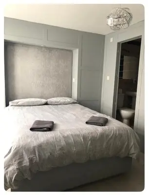 a bedroom with a large bed with two towels on it at The Elk in Blackpool
