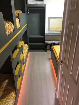 a small room with two bunk beds and a door at The Elk in Blackpool
