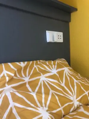 a bed with a white comforter in a bedroom at The Elk in Blackpool