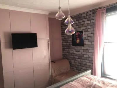 a bedroom with a bed and a tv on a wall at The Elk in Blackpool