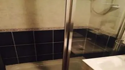 a bathroom with a glass shower with a sink at The Elk in Blackpool