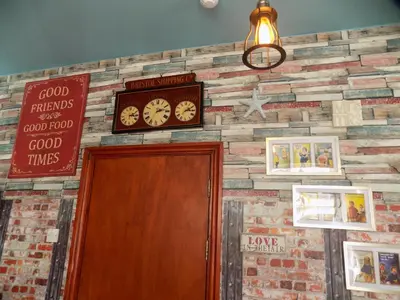 a brick wall with a clock above a door at Tracey's Driftwood in Blackpool
