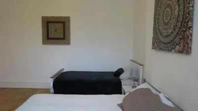 a room with a bed and a picture on the wall at Beach house in Crosby