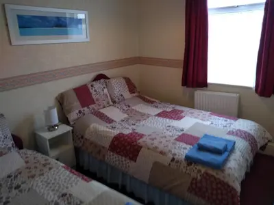 a bedroom with two beds and a window at Southview Hotel in Blackpool