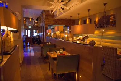 a restaurant with a table and chairs and a bar at The Townhouse Boutique Hotel in Barrow in Furness