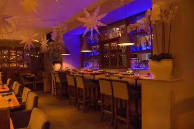 a restaurant with a bar with blue lighting at The Townhouse Boutique Hotel in Barrow in Furness