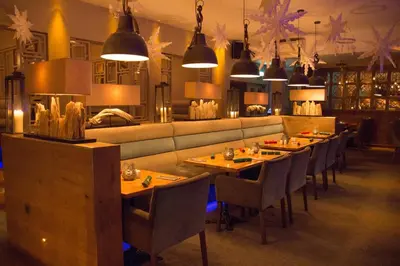 a restaurant with tables and chairs and a couch at The Townhouse Boutique Hotel in Barrow in Furness