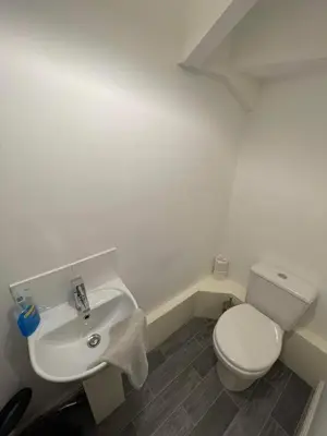 a bathroom with a white toilet and a sink at 2 Laurel Court in Ulverston