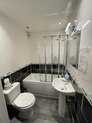 a bathroom with a toilet and a sink and a tub at 2 Laurel Court in Ulverston