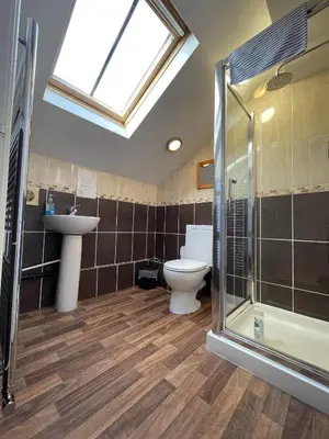 a bathroom with a toilet and a sink and a shower at 2 Laurel Court in Ulverston