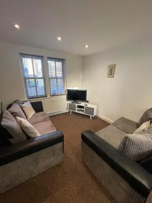 a living room with two couches and a flat screen tv at 4 Laurel Court in Ulverston