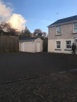 a house with a fence and a brick driveway at 4 Laurel Court in Ulverston