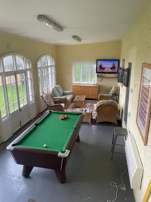 a living room with a pool table in it at Wyndcliffe in Grange Over Sands