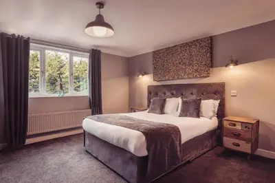a bedroom with a large bed and a window at The Dunes Hotel in Barrow in Furness