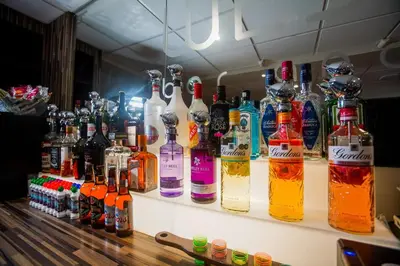 a bar with a lot of bottles of alcohol at The Georgian Hollies Hotel in Blackpool