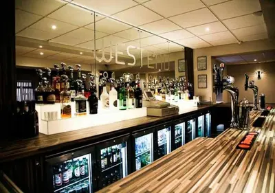 a bar with a lot of bottles of alcohol at The Georgian Hollies Hotel in Blackpool