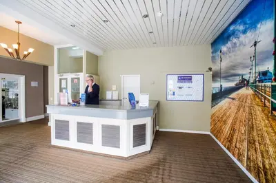 a woman standing at a counter in a room at The Georgian Hollies Hotel in Blackpool