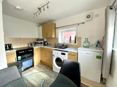 a kitchen with a washing machine and a washer and dryer at Kennedy House by Blackpool Service Apartments in Blackpool