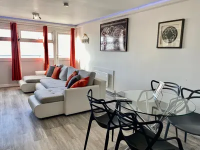 a living room with a couch and a glass table at Kennedy House by Blackpool Service Apartments in Blackpool