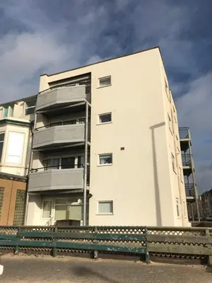 a white building with balconies on the side of it at Kennedy House by Blackpool Service Apartments in Blackpool
