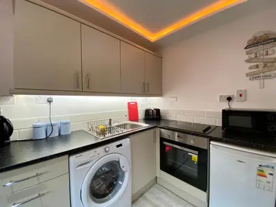 a kitchen with a washing machine and a washer at Kennedy House by Blackpool Service Apartments in Blackpool
