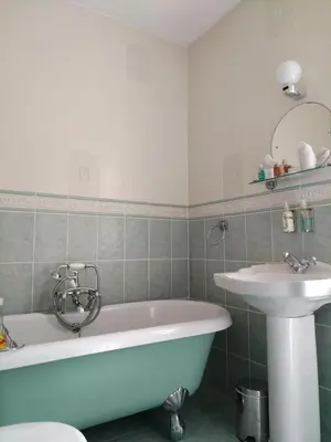 a bathroom with a tub and a sink at Bay Tree House Southport, United Kingdom in Southport