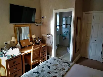 a bedroom with a desk and a bedroom with a bathroom at Bay Tree House Southport, United Kingdom in Southport