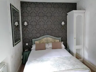 a bedroom with a white bed with two pillows at Bay Tree House Southport, United Kingdom in Southport