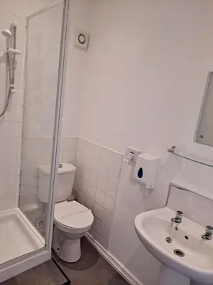 a bathroom with a toilet and a shower and a sink at The Sanderling in Morecambe
