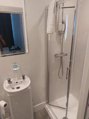 a bathroom with a shower and a sink at The Sanderling in Morecambe