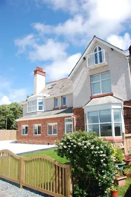 a house with a wooden fence in front of it at The Port House in Heysham