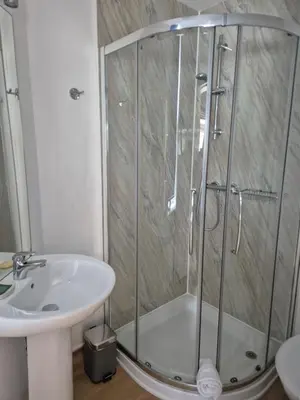 a bathroom with a shower and a sink at The Port House in Heysham