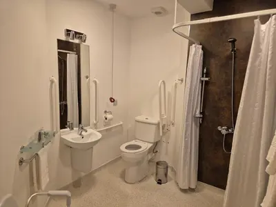 a bathroom with a toilet and a sink and a shower at The Port House in Heysham
