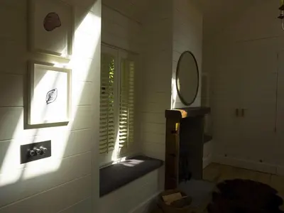 a bathroom with a mirror and a window with a sink at Castle View in Lancaster